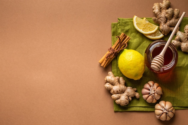 Honey glass pot, ginger, garlic, lemon to boost immune system. Natural ingredients for immunity stimulation and viruses protection. Healthy food against seasonal flu and cold, copy space background
