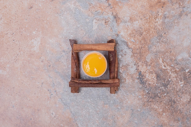 Egg yolk with cinnamons on marble surface.