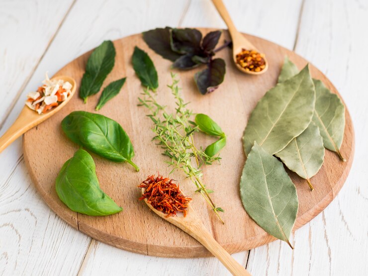 Dry leaves and spices on round wooden tray
